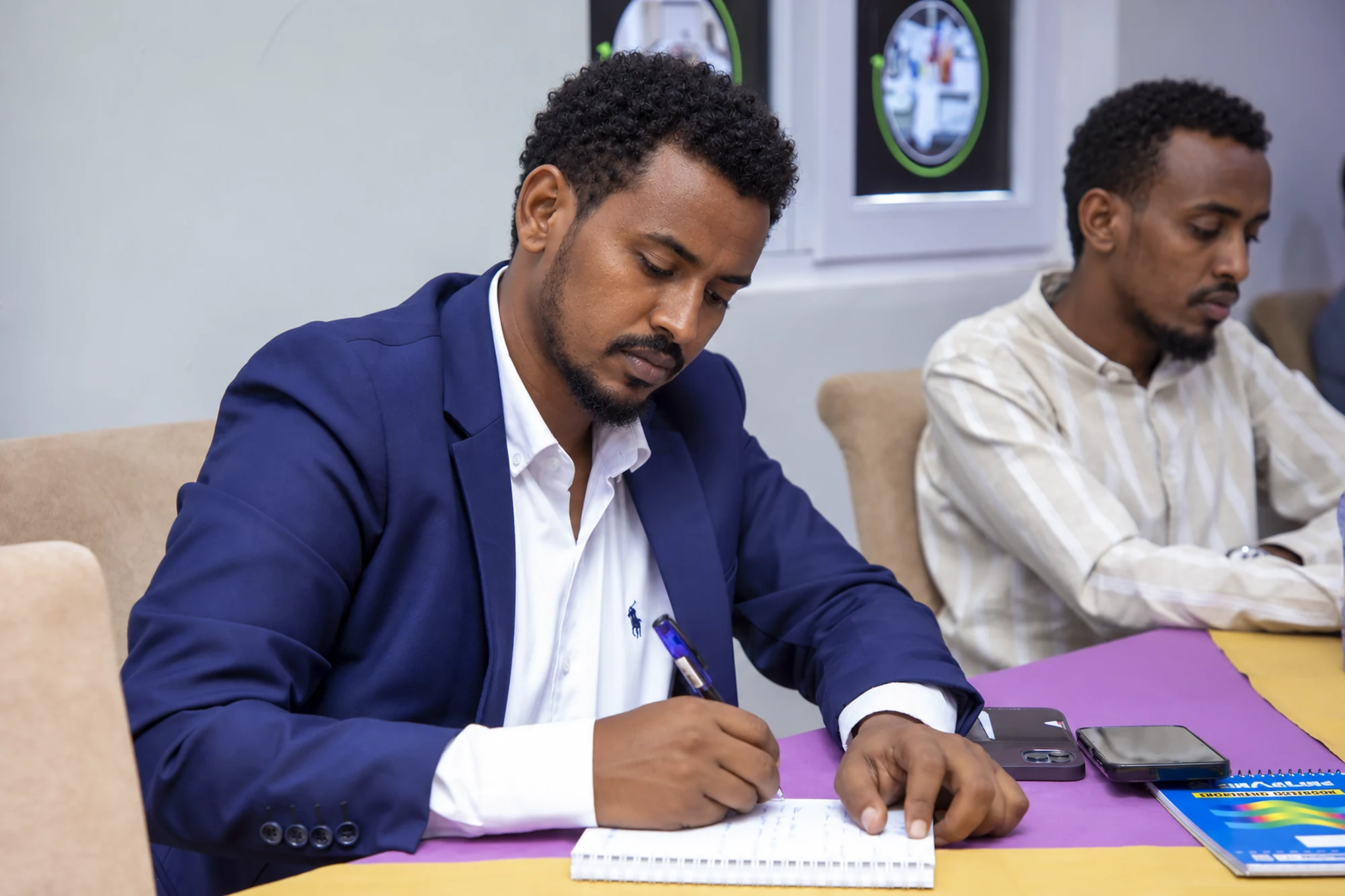 A workshop participant reviewing and recording information